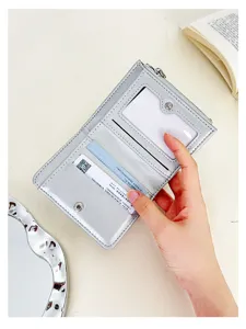 Detail showing the internal card slots of a metallic silver short bi-fold women's wallet