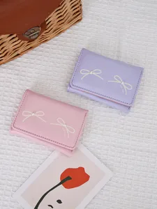 Cute Korean style women's short tri-fold wallet featuring bow print and pearl detail