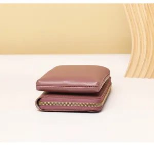 Close-up detail showing a mauve vertical phone bag and multi-functional lady wallet