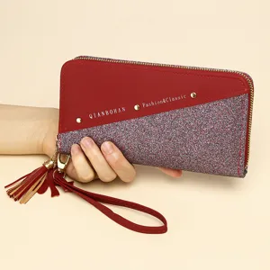 Red PU leather long wallet for women with glitter patchwork, wrist strap, and tassel detail