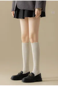Thickened fleece-lined calf socks in solid beige, styled with loafers and skirt for autumn.