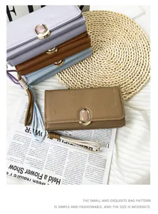 Detail shot of elegant textured leather wallets in multiple colors with stone clasps