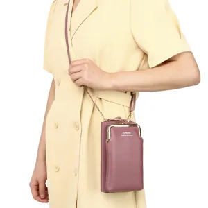 Fashionable mauve vertical crossbody phone bag shown on a model in a yellow dress