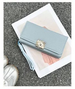 Fashionable light blue long trifold wallet for women with pebble texture and gold buckle detail