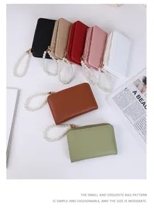 Detailed view of litchi pattern coin purses in various colors featuring pearl wrist straps.