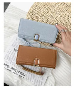 Long pebbled leather wallets in blue and brown with gold buckle and wrist strap