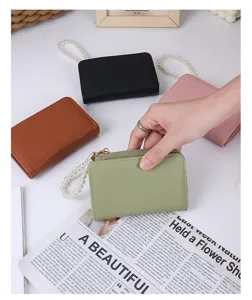 Collection of minimalist litchi grain small wallets featuring elegant pearl wristlet chains.