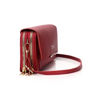 Detailed side view of red double-zipper crossbody phone bag for women with gold hardware