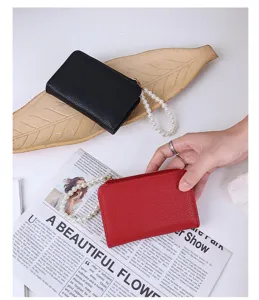 Detailed view of litchi pattern leather wallet with decorative pearl chain strap