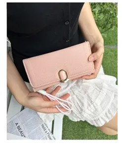 Elegant pink textured long wallet for women featuring a gold-tone gemstone buckle detail