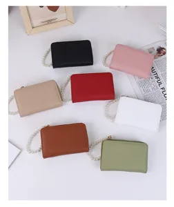 Detail view showing variety of litchi grain coin purses with elegant pearl wristlets