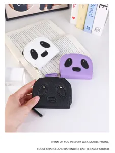 Detail of cute panda-shaped coin purses in black, white, and purple textured leather