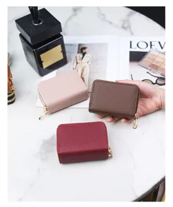 Close-up of colorful litchi grain leather accordion card holders with gold zippers