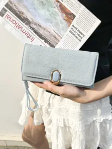 Elegant light blue women's long clutch wallet featuring a unique stone buckle and wristlet