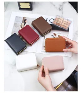 Collection of multi-color lychee pattern double zipper card holders on marble table