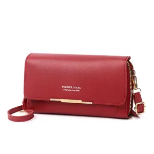 Detail view of a red multifunctional crossbody phone wallet featuring gold hardware