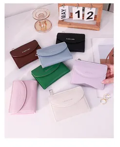 Collection of small colorful faux leather wallets with snap closure and gold lettering.