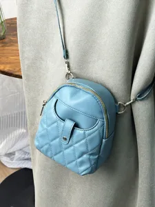 Light blue quilted mini crossbody bag in soft leather with rhombus pattern and zipper