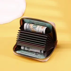 Detailed view showing the internal accordion slots of the pink zip-around card wallet