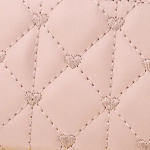 Close-up of pink leather wallet with quilted diamond pattern and heart embroidery.