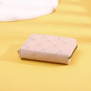 Detail of pink women's short wallet with elegant heart-shaped quilted pattern