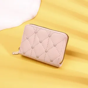Close-up view of elegant pink women's card holder featuring heart quilted pattern and zipper