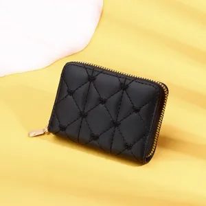 Detailed view of a stylish black women's short wallet featuring quilted heart patterns and gold zipper.