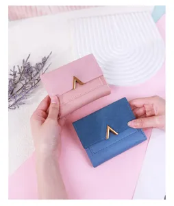 Close-up of pink and blue frosted PU leather tri-fold wallets with V-metal logo