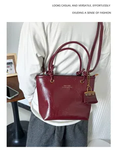 Detailed view of a vintage wine red leather tote bucket bag worn in a casual lifestyle setting