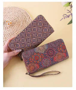 Detail view of two Bohemian style long wallets with ethnic floral and geometric patterns