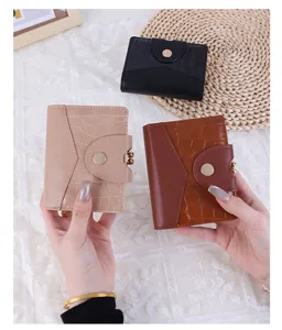 Close-up of short crocodile pattern wallets in multiple colors with metal snap button