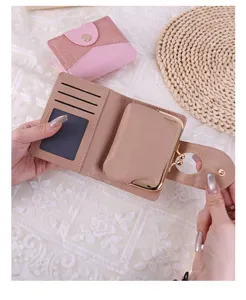 Detail view of interior card slots and detachable coin purse of a beige wallet