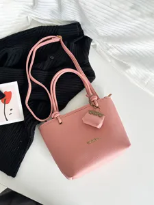 Elegant pink lychee grain leather tote bag with top handles and adjustable shoulder strap