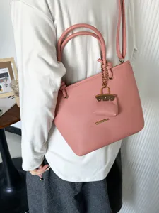 Pink lychee pattern leather tote bag with gold hardware and shoulder strap