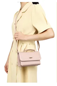 Simple pink women's crossbody bag styled with a summer dress for a commute look