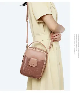 Detailed side view of a stylish crocodile pattern mini crossbody phone bag worn by a model