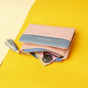 Close-up of a pink and blue color-block women's wallet showing the tassel zipper and coin slot.