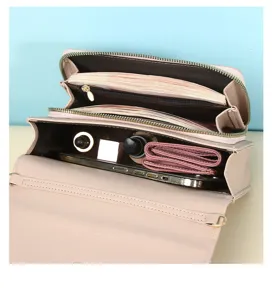 Close-up of pink minimalist crossbody bag interior showing multiple storage compartments