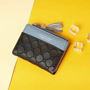 Detailed view of women's short color-block wallet with quilted pattern and tassel zipper