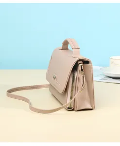 Side view of minimalist apricot handbag with textured finish and golden zipper detail