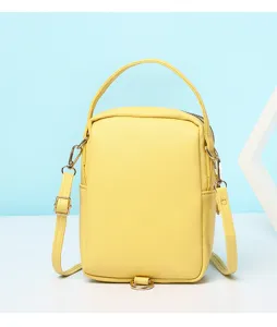 Small yellow minimalist crossbody phone bag with top handle and gold-tone hardware