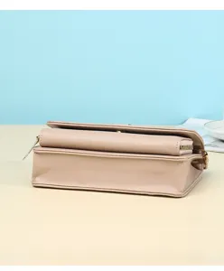 Side view of minimalist pink commute bag showing cross-grain texture and gold hardware