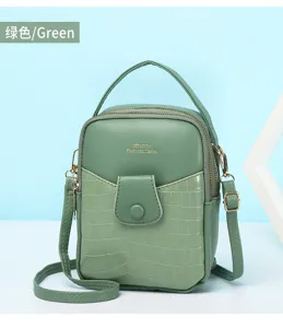 Detailed macro view of green mini crossbody phone bag featuring elegant stone texture finish