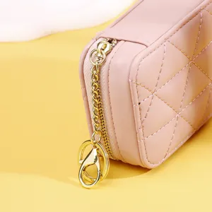 Detailansicht der rosa gesteppten Lippenstift-Tasche mit goldenem Reißverschluss.