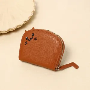 Detail view of the cute brown cat-shaped coin purse with tail zipper pull.
