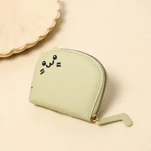 Close-up of cute green cartoon cat coin purse with embroidered face and tail zipper