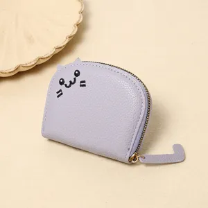 Detailed view of lavender cartoon cat coin purse with embroidered face and tail zipper.