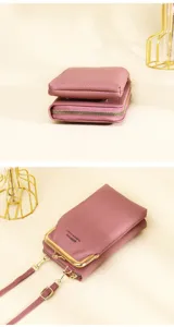 Detailed view of pink crossbody phone wallet with pebble leather and gold clasp