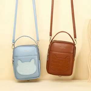 Cute mini crossbody phone bags for women with animal face pocket in blue and brown.