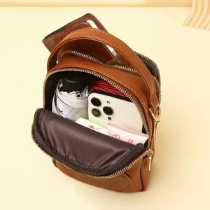 Multi-functional brown mini crossbody phone bag showing spacious internal storage capacity